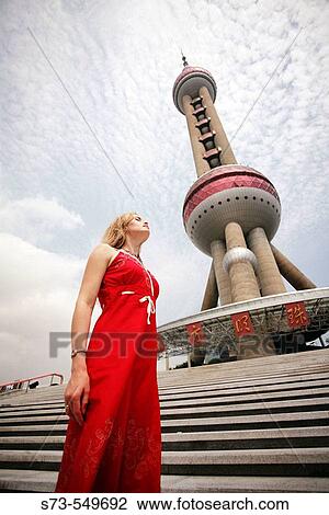 Woman next to TV tower. Shanghai city, the Pearl of Orient. China. View Large Photo Image Stock Image - Woman next to TV tower. Shanghai city, the Pearl of Orient. China.. Fotosearch