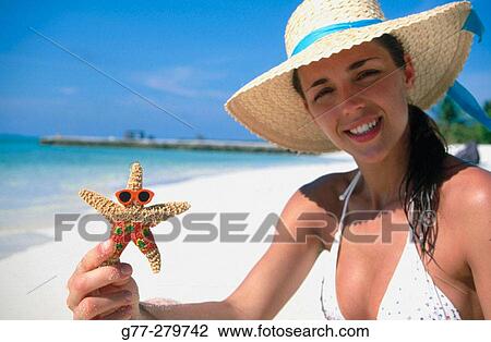 Stock Image - Woman on a beach in Ari Atoll, Maldives. Fotosearch