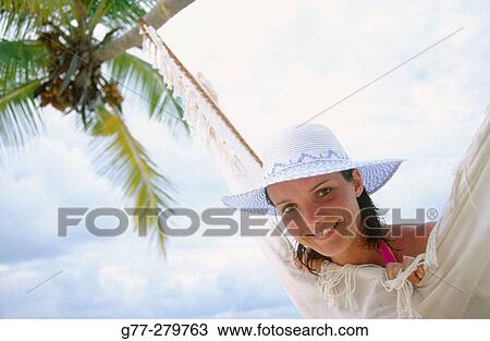 Stock Image - Woman on a beach in Ari Atoll. Maldives. Fotosearch