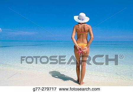 Stock Photo - Woman on a beach in Ari Atoll. Maldives. Fotosearch