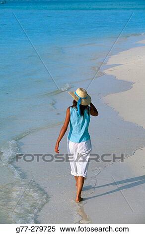 Stock Photography - Woman on a beach. White Sands Resort and Spa. Ari Atoll, Maldives. Fotosearch