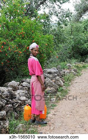 Stock Image - woman on a path of Oum-er-Rbia vallee, Khenifra region, Middle Atlas, Morocco, North Africa. Fotosearch