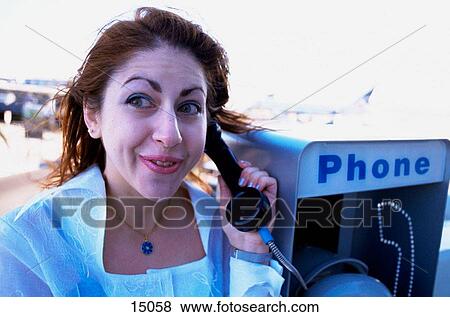 Woman on a phone at the airport View Large Photo Image Stock Photo - Woman on a phone at the airport. Fotosearch