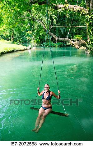 Woman on a swing in the Blue Lagoon in Vang Vieng, Laos. View Large Photo Image Stock Photo - Woman on a swing in the Blue Lagoon in Vang Vieng, Laos.. Fotosearch