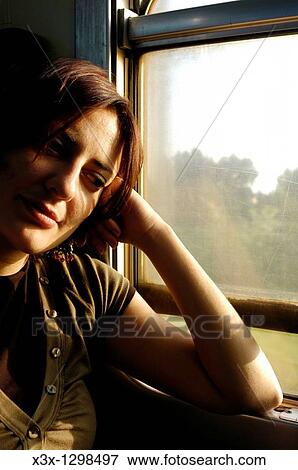 Woman on a train View Large Photo Image Stock Photo - Woman on a train. Fotosearch