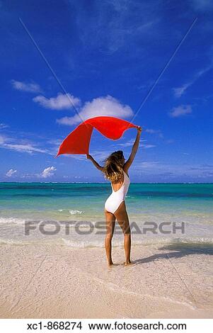 Woman on beach holding a towel, Punta Cana, Dominican Republic, Caribbean View Large Photo Image Picture - Woman on beach holding a towel, Punta Cana, Dominican Republic, Caribbean. Fotosearch