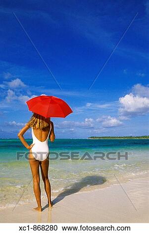 Woman on beach holding an umbrella, Punta Cana, Dominican Republic, Caribbean View Large Photo Image Stock Image - Woman on beach holding an umbrella, Punta Cana, Dominican Republic, Caribbean. Fotosearch