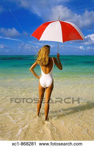 Woman on beach holding an umbrella, Punta Cana, Dominican Republic, Caribbean View Large Photo Image Stock Image - Woman on beach holding an umbrella, Punta Cana, Dominican Republic, Caribbean. Fotosearch