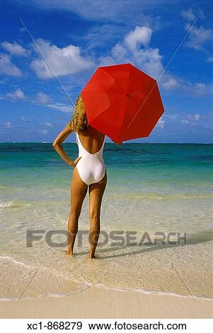 Woman on beach holding an umbrella, Punta Cana, Dominican Republic, Caribbean View Large Photo Image Stock Photo - Woman on beach holding an umbrella, Punta Cana, Dominican Republic, Caribbean. Fotosearch