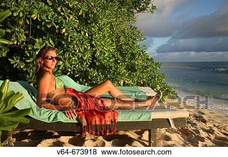 Stock Photo - Woman on beach, hotel Lemuria Resort, Praslin Island, Seychelles. Fotosearch