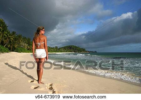 Stock Photo - Woman on beach, hotel Lemuria Resort, Praslin Island, Seychelles. Fotosearch