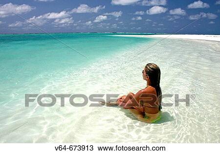 Stock Image - Woman on beach, Maldive Islands. Fotosearch