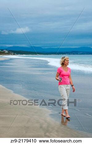 Woman on beach walking barefoot on wet sand, Mosselbay, Garden Route, South Africa. View Large Photo Image Stock Image - Woman on beach walking barefoot on wet sand, Mosselbay, Garden Route, South Africa.. Fotosearch