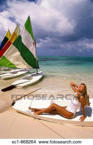 Woman on beach with sailboats, Punta Cana, Dominican Republic, Caribbean View Large Photo Image Picture - Woman on beach with sailboats, Punta Cana, Dominican Republic, Caribbean. Fotosearch