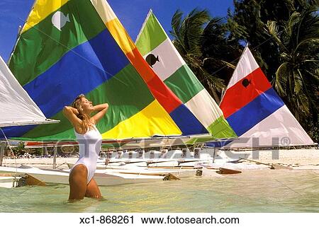 Woman on beach with sailboats, Punta Cana, Dominican Republic, Caribbean View Large Photo Image Stock Image - Woman on beach with sailboats, Punta Cana, Dominican Republic, Caribbean. Fotosearch