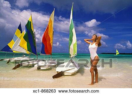 Woman on beach with sailboats, Punta Cana, Dominican Republic, Caribbean View Large Photo Image Stock Image - Woman on beach with sailboats, Punta Cana, Dominican Republic, Caribbean. Fotosearch