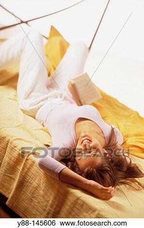 Woman on bed View Large Photo Image Stock Photograph - Woman on bed. Fotosearch