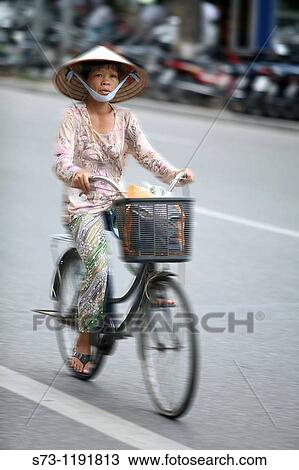 Woman on bicycle in Hanoi, Vietnam View Large Photo Image Stock Image - Woman on bicycle in Hanoi, Vietnam. Fotosearch