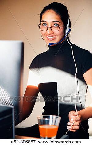 Woman on computer with headphones View Large Photo Image Stock Photo - Woman on computer with headphones. Fotosearch