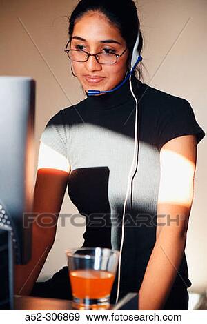 Woman on computer with headphones View Large Photo Image Stock Photo - Woman on computer with headphones. Fotosearch