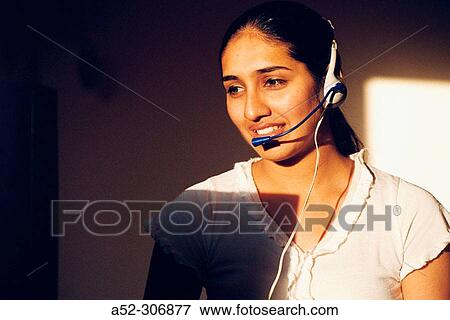 Woman on computer with headphones View Large Photo Image Stock Photo - Woman on computer with headphones. Fotosearch