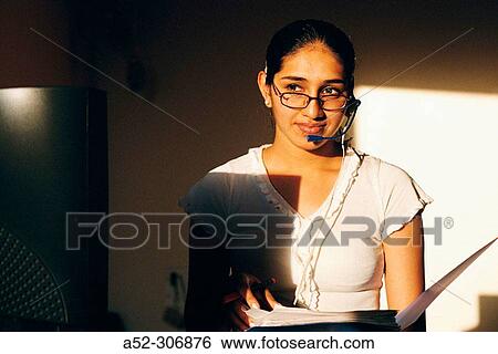 Woman on computer with headphones View Large Photo Image Stock Photograph - Woman on computer with headphones. Fotosearch