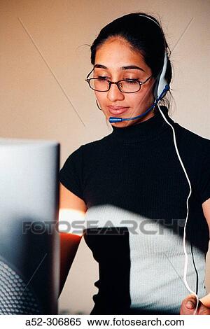Woman on computer with headphones View Large Photo Image Stock Photography - Woman on computer with headphones. Fotosearch