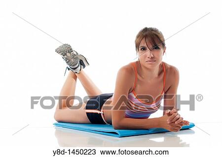 Stock Image - Woman on fitness mat ready to work out. Fotosearch