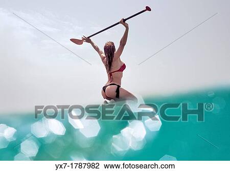Woman on her stand up paddle surf board. View Large Photo Image Stock Image - Woman on her stand up paddle surf board.. Fotosearch
