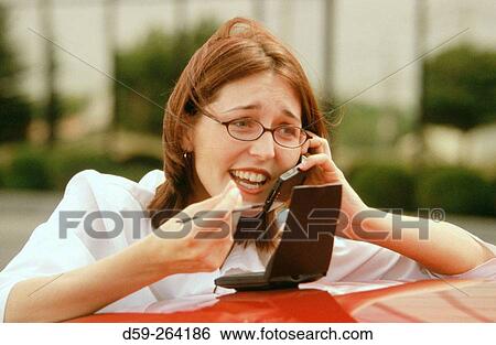 Woman on mobile phone with her personal organizer View Large Photo Image Stock Photograph - Woman on mobile phone with her personal organizer. Fotosearch