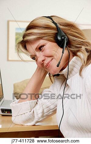 Woman on phone in front of computer. View Large Photo Image Stock Photo - Woman on phone in front of computer.. Fotosearch