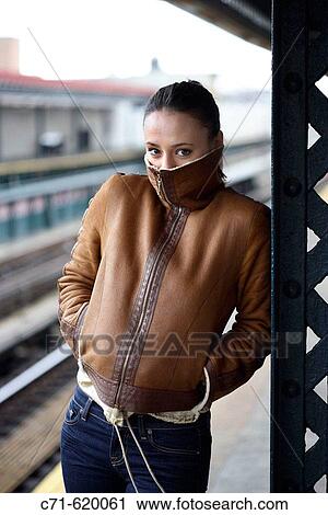 Stock Image - woman on railroad platform/subway freezing. Fotosearch