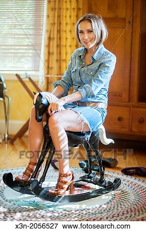 Woman on rocking horse. View Large Photo Image Stock Photo - Woman on rocking horse.. Fotosearch