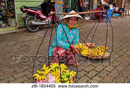 Woman on street in Saigon Ho Chi Minh City with fruit on baskets on shoulder View Large Photo Image Stock Photography - Woman on street in Saigon Ho Chi Minh City with fruit on baskets on shoulder. Fotosearch