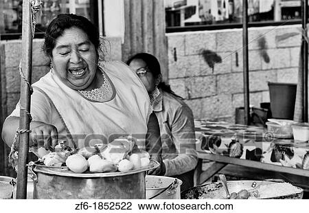 Woman on street selling and stirring soup in small village of Otavalo Ecuador South America View Large Photo Image Stock Image - Woman on street selling and stirring soup in small village of Otavalo Ecuador South America. Fotosearch