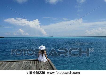 Stock Photography - Woman on swimmingpool, Maldives, Indian Ocean. Fotosearch