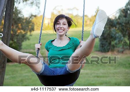 Stock Photo - Woman on swing. Fotosearch