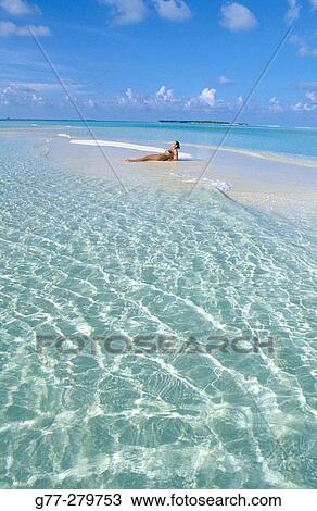 Stock Image - Woman on the beach in White Sands Resort and Spa. Ari Atoll. Maldives. Fotosearch