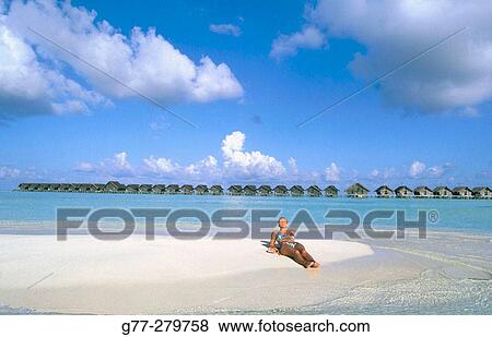 Woman on the beach in White Sands Resort and Spa. Ari Atoll. Maldives View Large Photo Image Stock Photo - Woman on the beach in White Sands Resort and Spa. Ari Atoll. Maldives. Fotosearch
