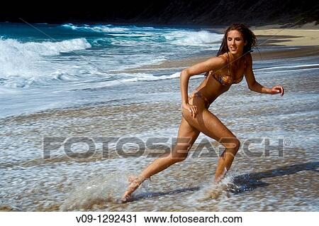 Stock Image - Woman on the beach, Kauai, Hawaii. Fotosearch