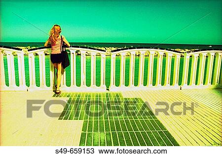 Woman on the beach promenade, Altea. Alicante Province. Spain. View Large Photo Image Stock Image - Woman on the beach promenade, Altea. Alicante Province. Spain.. Fotosearch