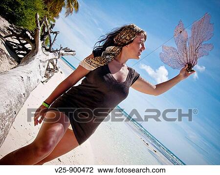 Stock Image - Woman on the beach, Saona Island, Dominican Republic. Fotosearch