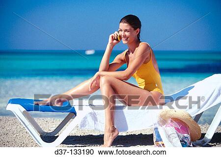 Woman on the beach, talkin on mobile phone View Large Photo Image Stock Image - Woman on the beach, talkin on mobile phone. Fotosearch