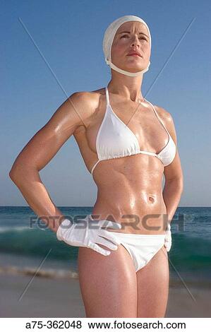 Woman on the beach wearing bathing cap and gloves View Large Photo Image Stock Photo - Woman on the beach wearing bathing cap and gloves. Fotosearch