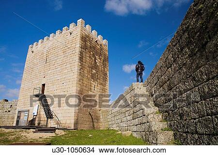 Picture - Woman on the castle walls of Celorico da Beira village, in Beira Alta Guarda District Portugal. Fotosearch