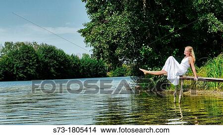Woman on the pier in Lake Avral, Kirillovka, Samara Region, Russian Federation View Large Photo Image Picture - Woman on the pier in Lake Avral, Kirillovka, Samara Region, Russian Federation. Fotosearch