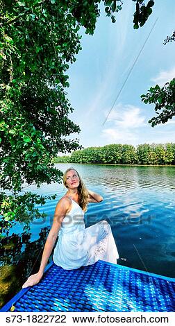 Woman on the pier in Lake Avral, Kirillovka, Samara Region, Russian Federation View Large Photo Image Stock Image - Woman on the pier in Lake Avral, Kirillovka, Samara Region, Russian Federation. Fotosearch