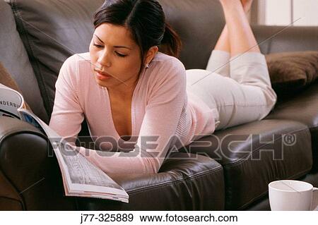 Woman on the sofa reading View Large Photo Image Stock Photo - Woman on the sofa reading. Fotosearch