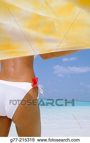 Stock Photo - Woman on tropical beach. Maldives Islands. Fotosearch