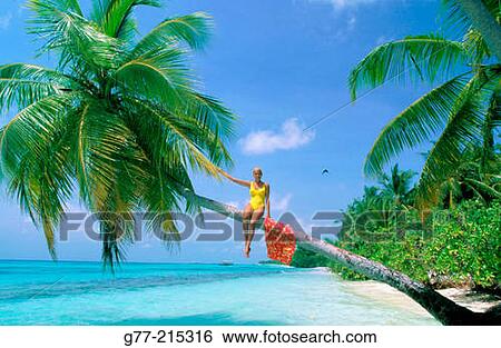Stock Photograph - Woman on tropical beach. Maldives Islands. Fotosearch